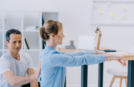 businesswoman working out with personal trainer at office