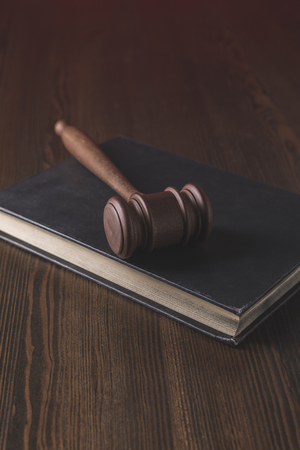 juridical book with hammer on wooden table, law conceptの写真素材