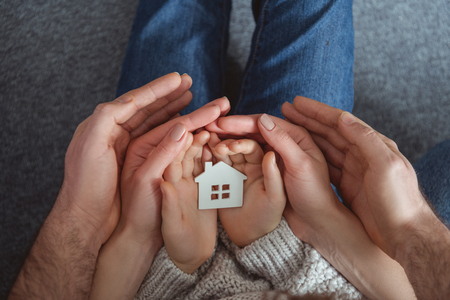 cropped shot of family holding small house model in handsの写真素材