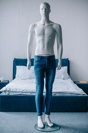 selective focus of layman doll in jeans in bedroomの写真素材