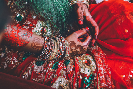 close-up partial view of woman in traditional clothes and mehendi on hands in Nepalの写真素材