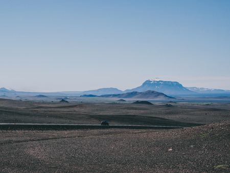 one car on road with black sand and mountains around, Icelandの写真素材