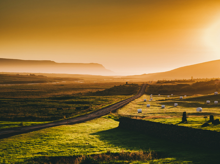 beautiful landscape with road and mountains at sunset, Icelandの写真素材