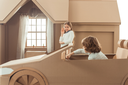 side view of kid arrived for girlfriend on cardboard carの写真素材