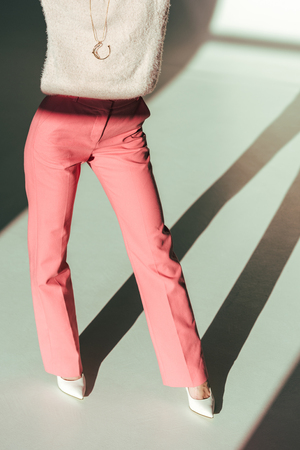 cropped shot of girl in pink clothes posing in studioの写真素材