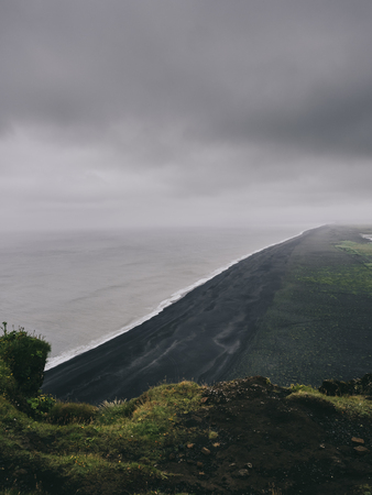 scenic view of black sand beach from cliff, Vik, Icelandの写真素材