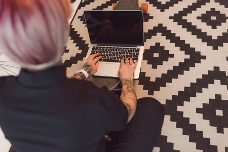 cropped shot of young businesswoman using laptop with blank screenの写真素材