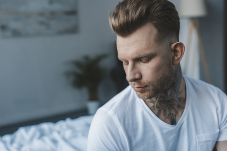handsome thoughtful man with closed eyesの写真素材