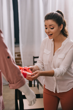 woman pretending to except gift from mannikin, loneliness and perfect man dream conceptの写真素材