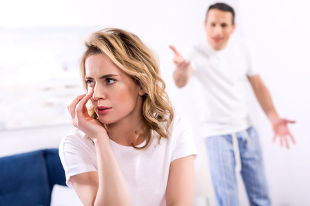 selective focus of couple having argument at homeの写真素材