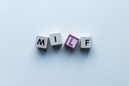 top view of wooden cubes with word Milf on blue tabletopの写真素材