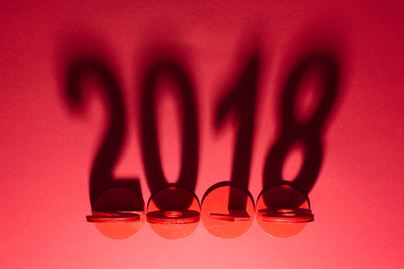 top view of 2018 year sign shadow isolated on redの写真素材