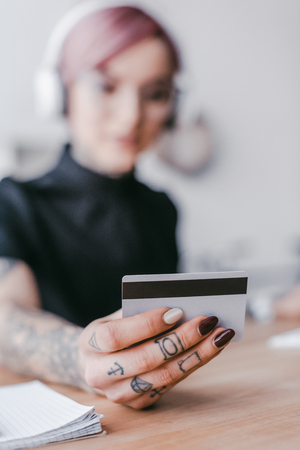 close-up view of young woman holding credit cardの写真素材