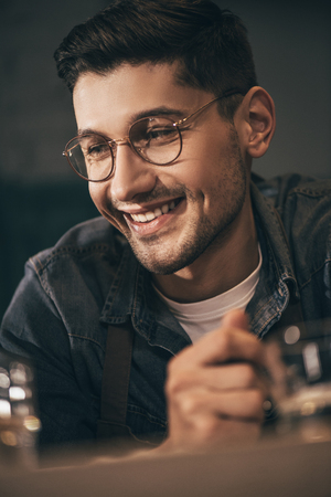 portrait of cheerful man in eyeglasses looking awayの写真素材
