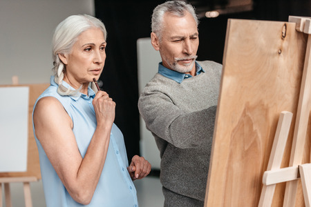 focused senior students painting together at art classの写真素材