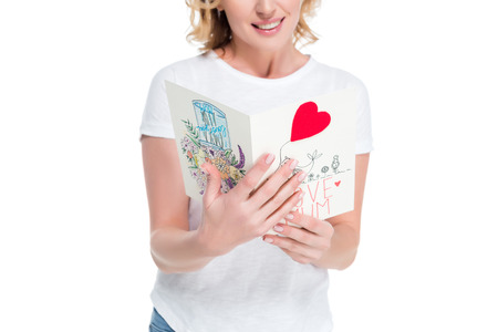 cropped shot of woman with postcard in hands isolated on white, mothers day conceptの写真素材