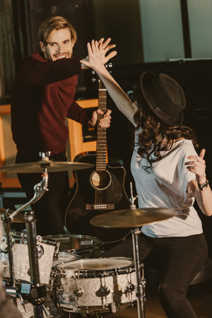 young musicians giving high five on repetitionの写真素材