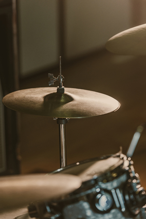 close-up shot of drum cymbals under spotlight on stageの写真素材