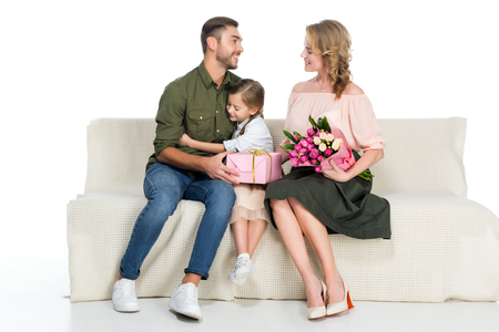 happy family with presents on sofa isolated on whiteの写真素材