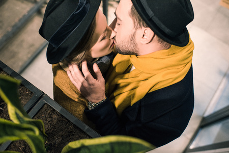 young attractive couple kissing in autumn outfitの写真素材