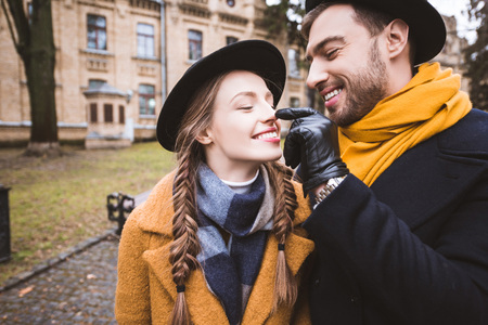 happy beardman touching nose of his girlfriend by fingerの写真素材