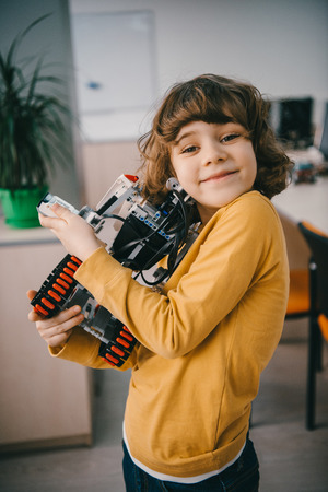happy little kid embracing with diy robotの写真素材