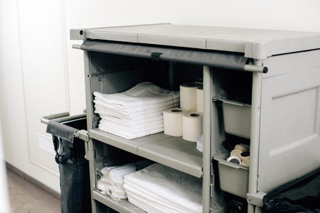 close-up shot of housekeeping cart with clean towels at hotelの写真素材
