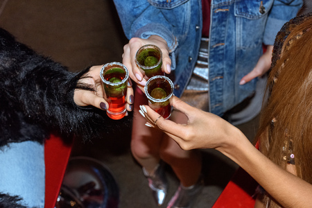cropped shot of stylish women holding glasses with cocktails