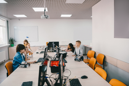 group of kids working with computers on machinery classの写真素材