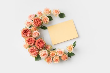 envelope surrounded by beautiful pink flowers isolated on whiteの写真素材