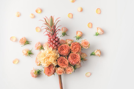 pink pineapple in flowers bouquet isolated on whiteの写真素材