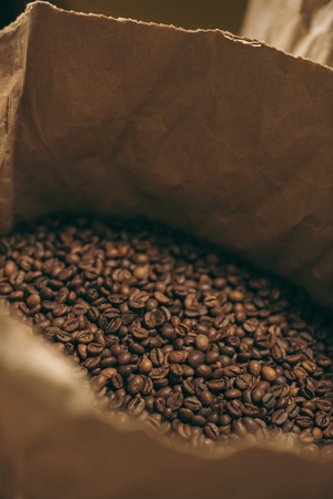 close up view of coffee beans in paper bagの写真素材