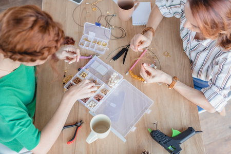 high angle view of young women in handmade accessories workshop