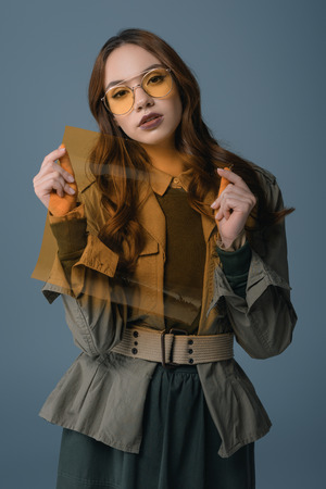 beautiful stylish girl posing in autumn outfit with filter for fashion shoot, isolated on greyの写真素材
