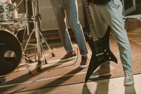 cropped shot of musicians with instruments at studioの写真素材