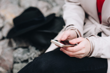 cropped shot of woman using smartphone outdoorsの写真素材