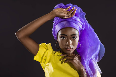 attractive african american woman in stylish vintage clothing isolated on blackの写真素材