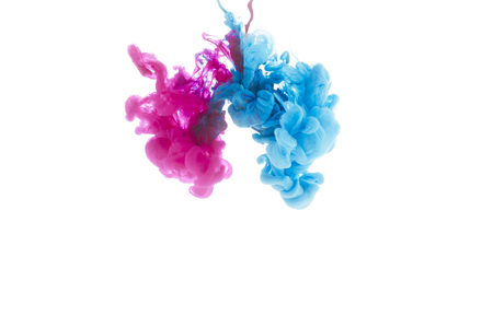 mixing of blue and pink paint splashes isolated on whiteの写真素材