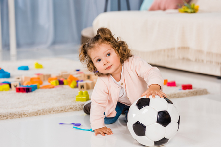 adorable kid playing with football ballの写真素材