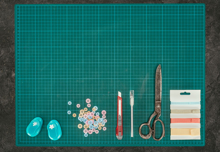 Top view of scale with tools for scrapbooking on gray surfaceの写真素材