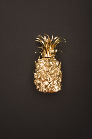 close up view of golden pineapple isolated on blackの写真素材