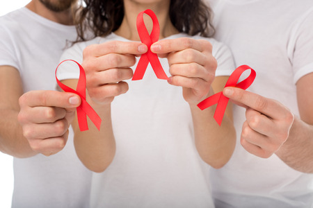 cropped shot of group of people with aids ribbons in hands isolated on whiteの写真素材