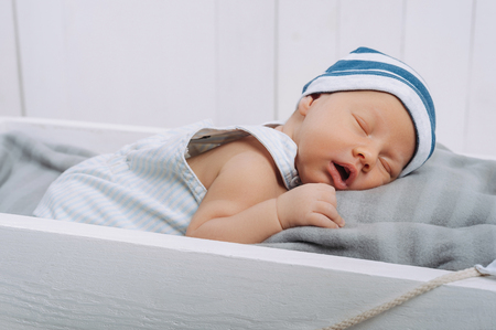 portrait of sleeping innocent infant baby in hatの写真素材