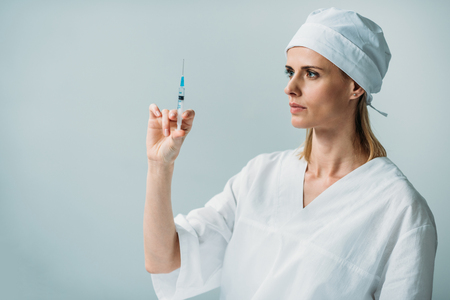 female doctor holding syringe with liquidの写真素材