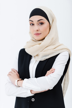 portrait of muslim businesswoman with arms crossed isolated on greyの写真素材