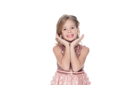 adorable smiling child in pink dress, isolated on whiteの写真素材