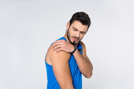 young man with pain in shoulder isolated on white