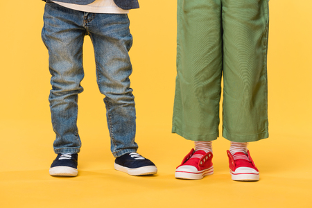 partial view of kids in casual clothing isolated on yellowの写真素材