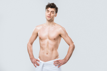 handsome sexy shirtless man posing in towel isolated on greyの写真素材