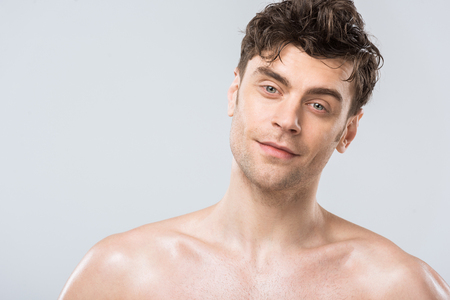 portrait of handsome young brunette man isolated on greyの写真素材